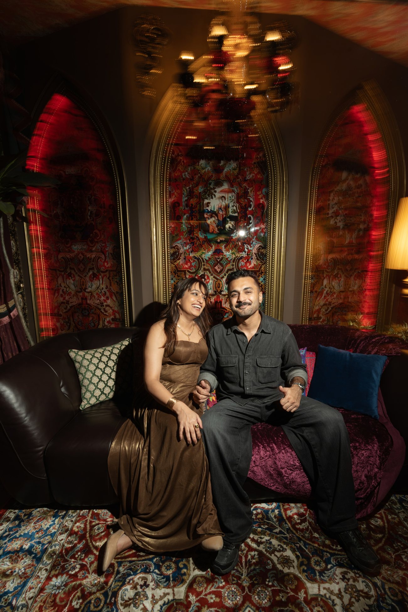 Shivika and Abhinav, the founders of Archipixels, seated on a velvet sofa