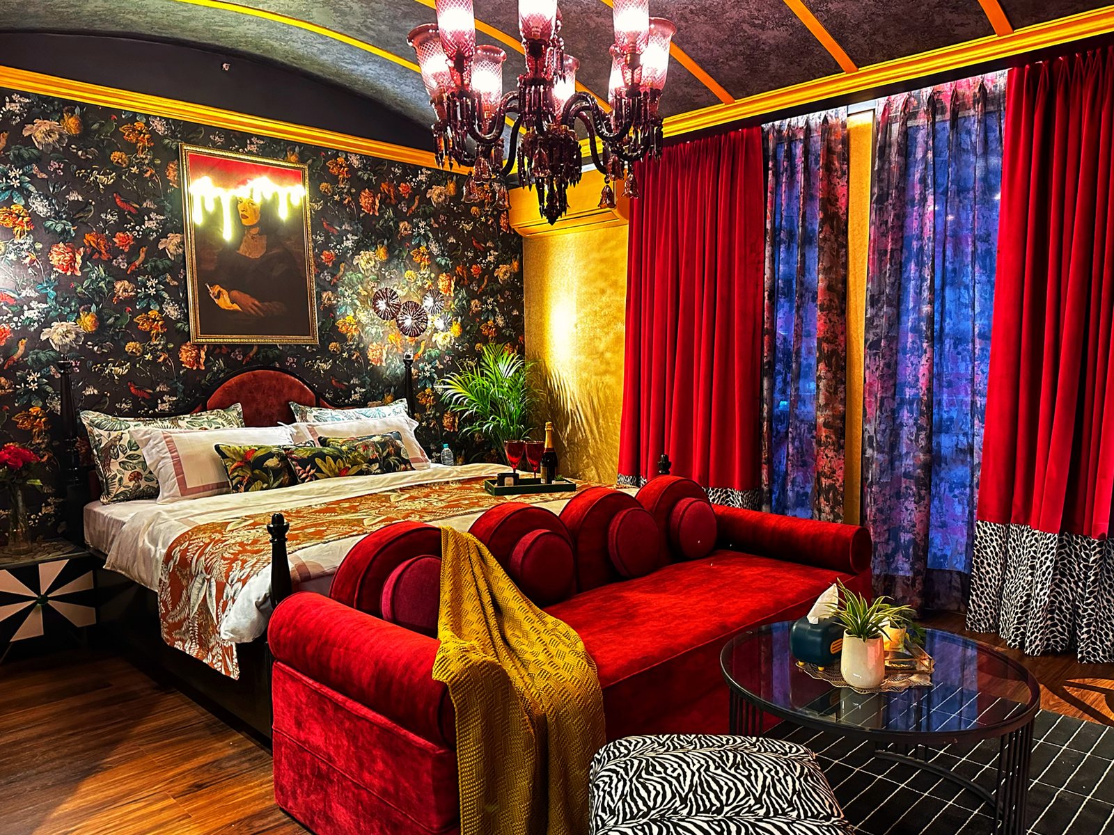 Helios Maximus bedroom with crimson velvet and floral wallpaper