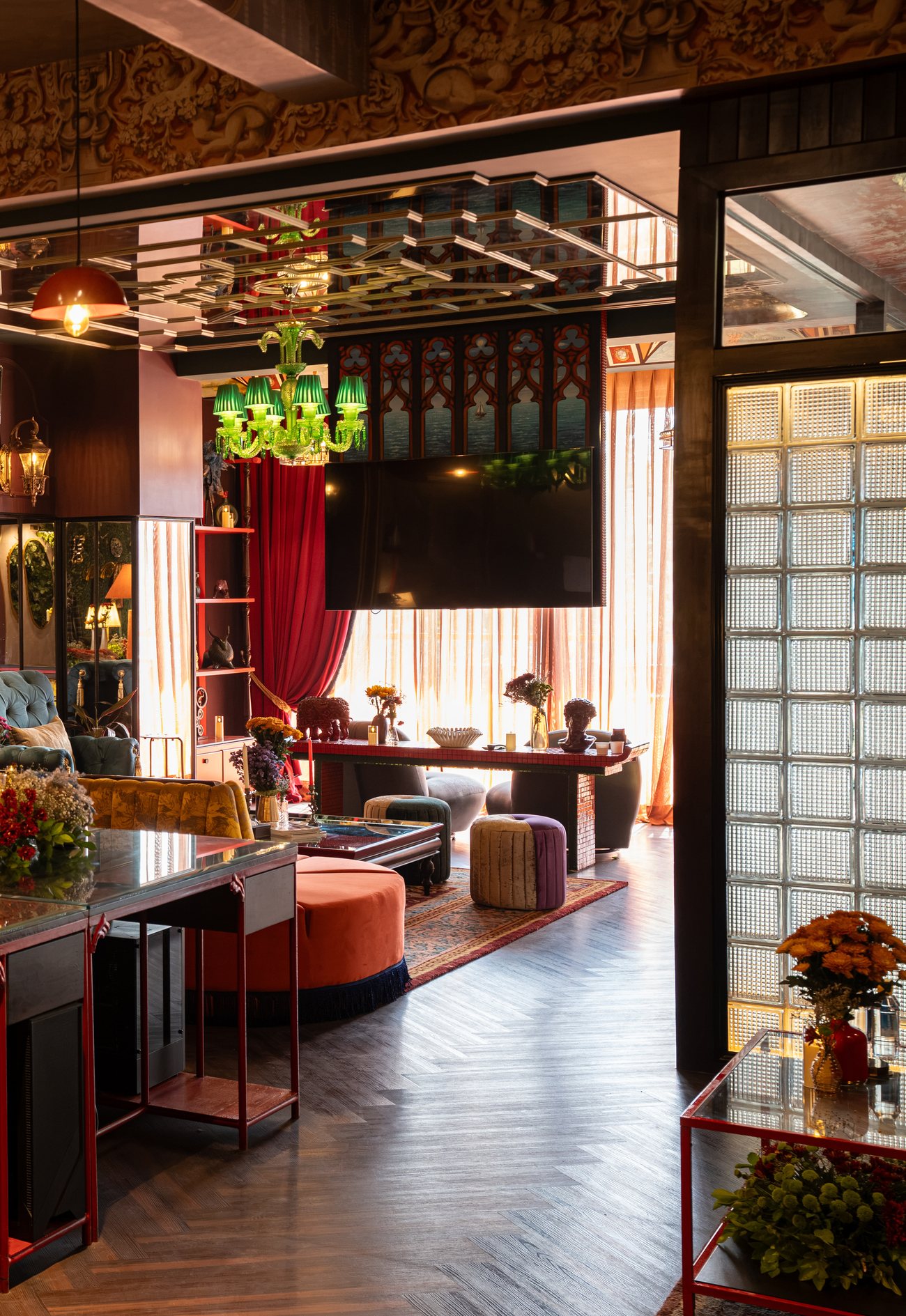 A layered, colourful Archipixels interior with hanging lamps and patterned floors