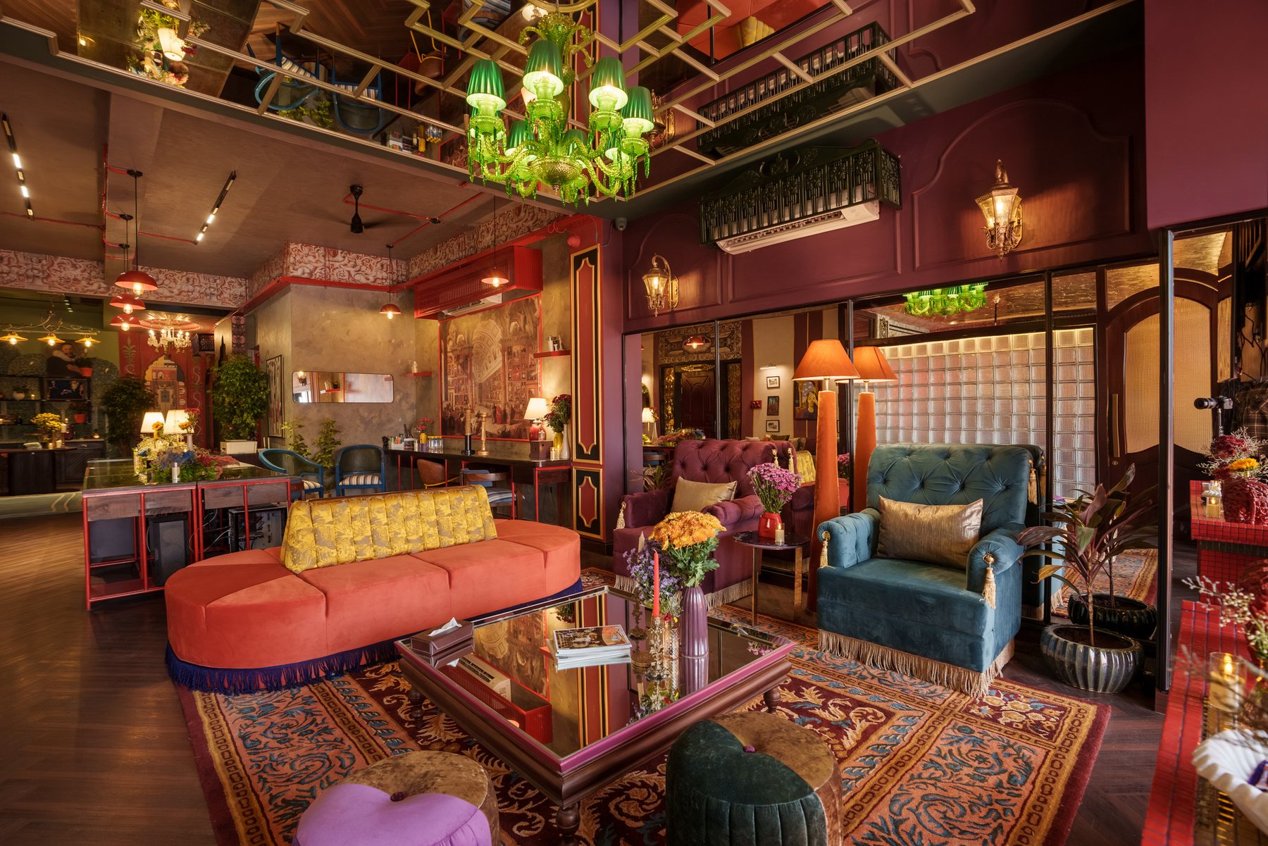 The Archipixels studio: a lounge with a green glass pendant, coral sofa and patterned rugs